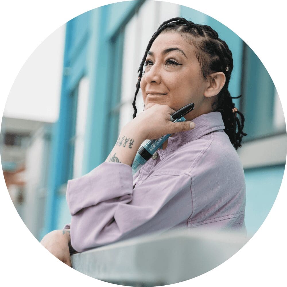 photograph of black man wearing a toque. His right hand is partially covering his mouth. 